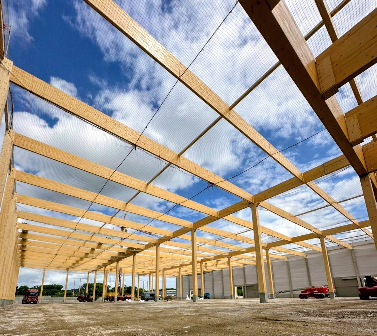 Timber roof structure against blue sky